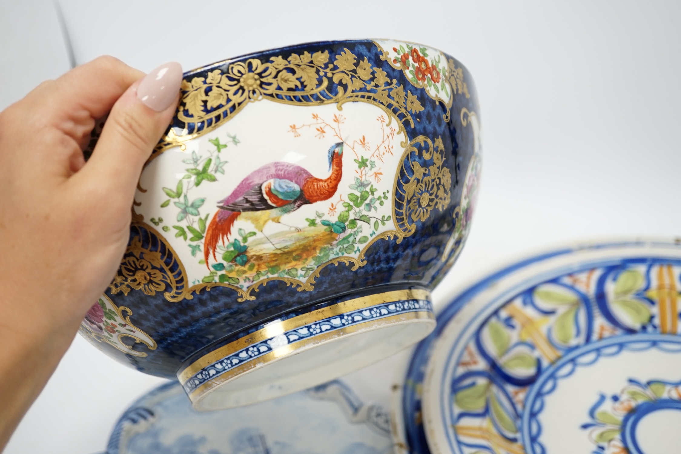 A Delft blue and white plaque, two continental tin-glazed dishes, one signed V.M.D, and a Booths scale-blue bowl, largest 35cm in diameter. Condition - largest dish poor, others fair